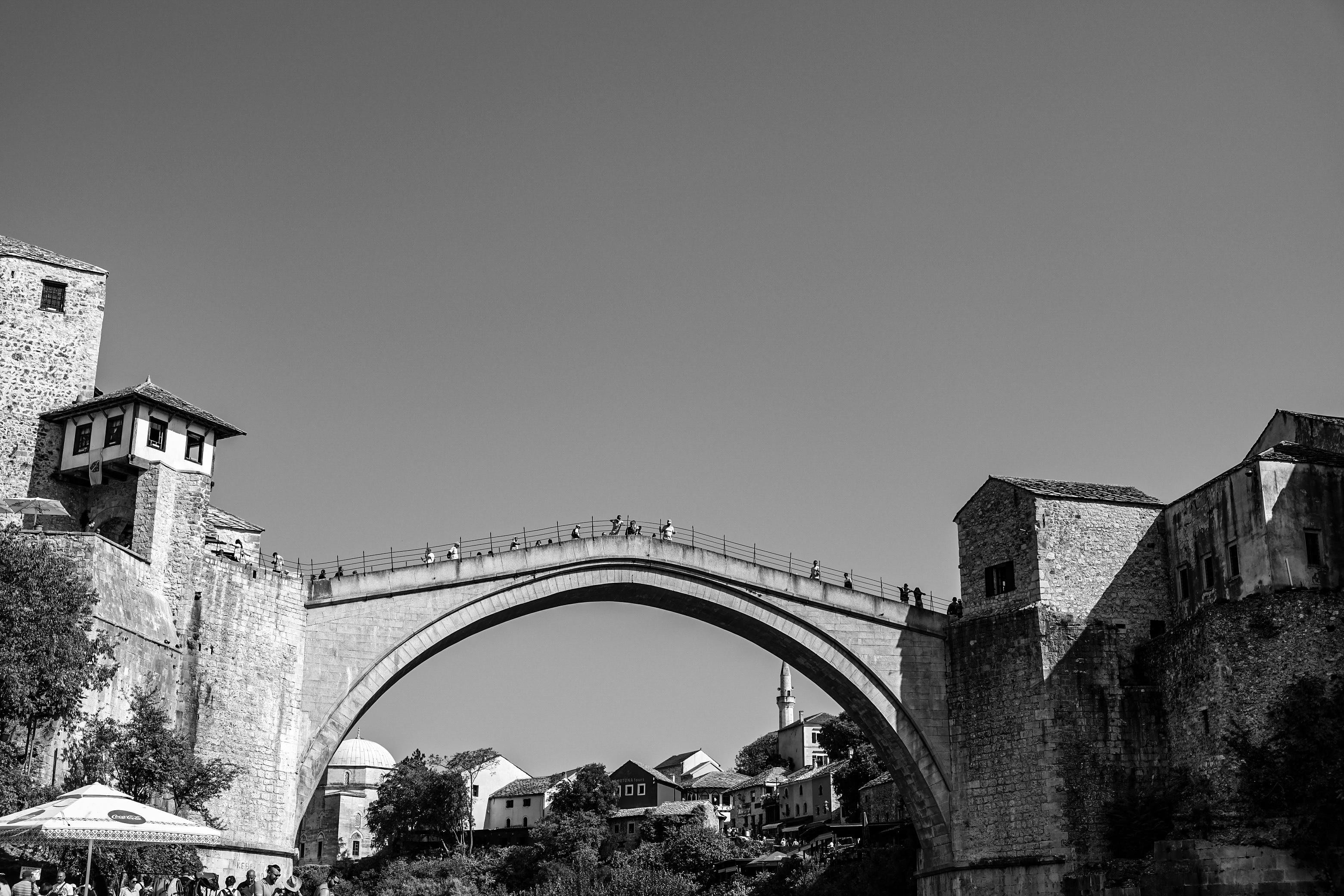 Historic Stari Most bridge in Mostar, Bosnia and Herzegovina, spanning the Neretva River with stone towers and traditional ar